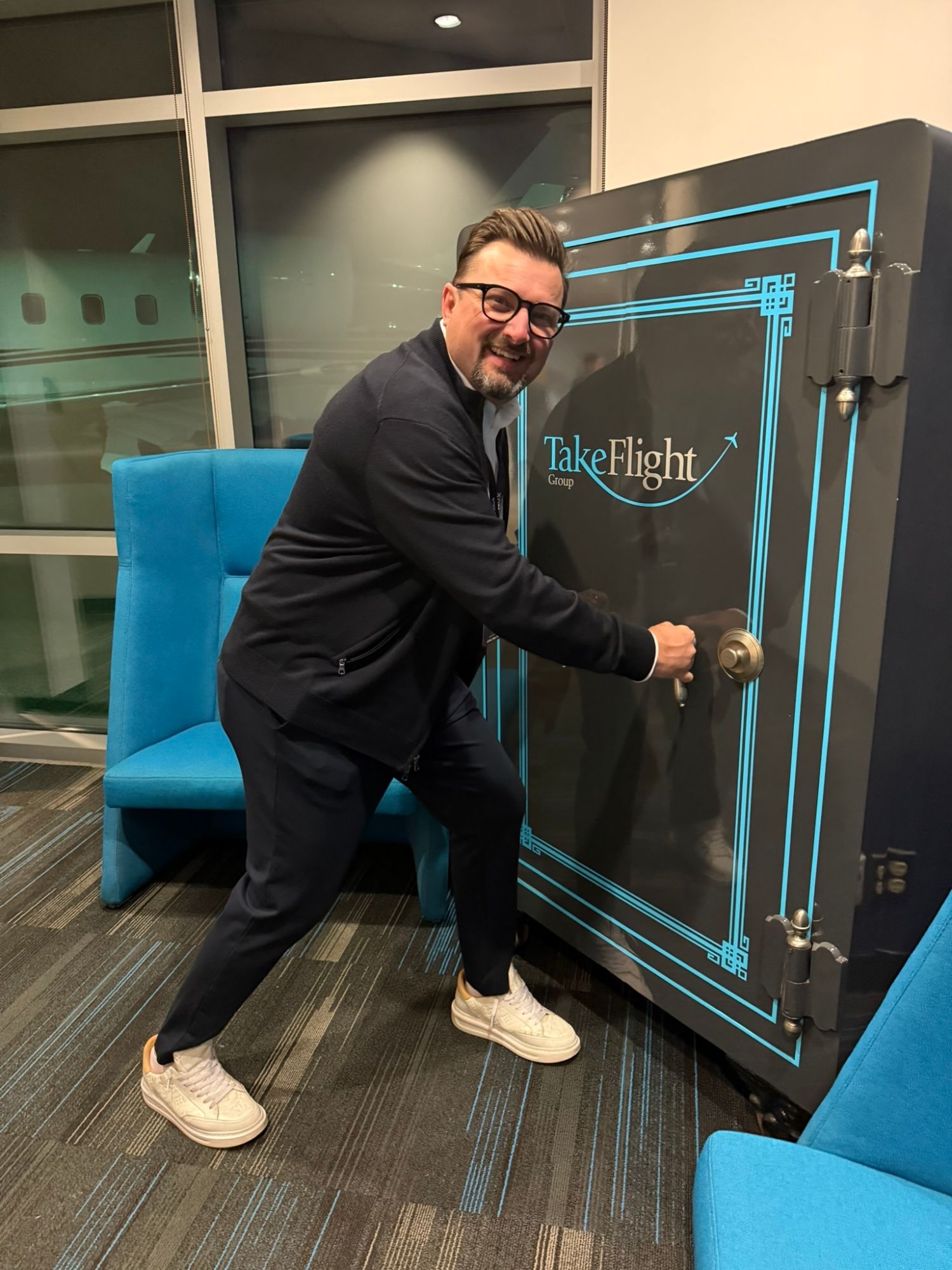 Danijel pulling open the door of a giant TakeFlight Group vault